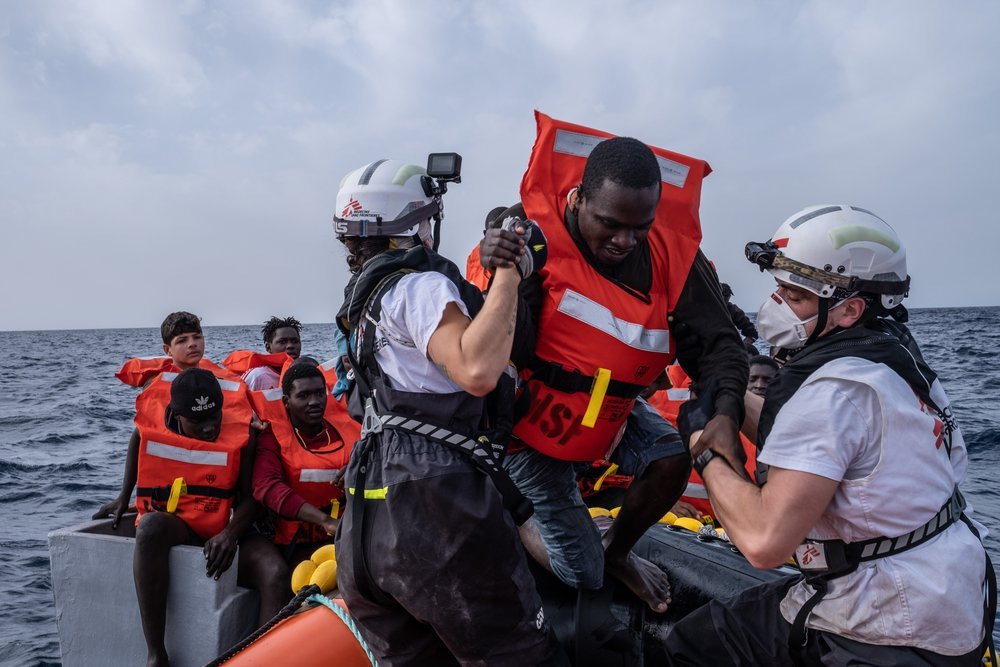 On the left side of the boat, Hassan, is waiting patiently to be transferred to MSF&#039;s RHIB.