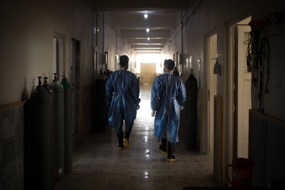 Two nurses walk in the corridors of the specialised COVID-19 ward, in the Raqqa National hospital. (June, 2021).