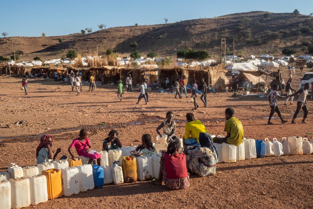 Refugees with their jerry cans at a water point in Um Rakuba refugee camp.