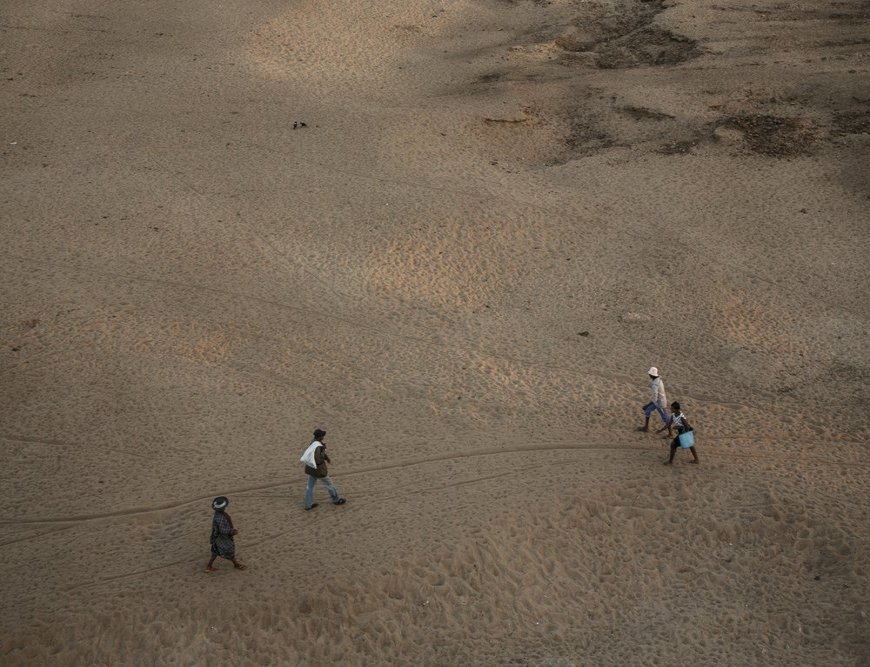 People cross the Mandrare riverbed which is often dry during the southern winter (between April and October), near Amboasary Atsimo on the National Road 13 (RN13). (August, 2021).