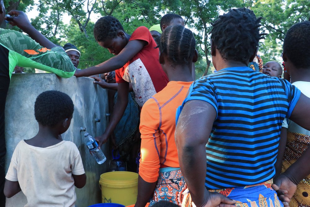 People are seen collecting water at a water point at Bangula camp where people displaced by Tropical Cyclone Ana are residing. MSF is providing WASH facilities at the camp. (February, 2022).
